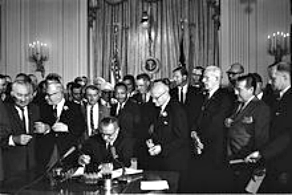 Johnson signs the Civil Rights Bill of 1964 and forever changes politics