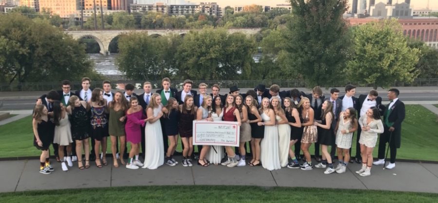Homecoming group poses with check of the money they saved to donate to the Red Cross