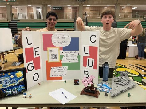 Photo By: Bennett Crater. Patrick Kiely and Abid Hasan show off their clubs sign at the activities fair.