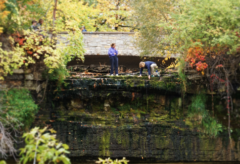 Two people stand 53 feet high at the edge of what was once the roaring Minnehaha falls. 