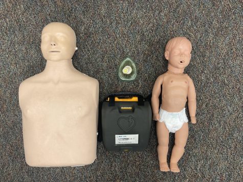 CPR dummies, a defibrillator, and a oxygen mask from Mr. Potts classroom