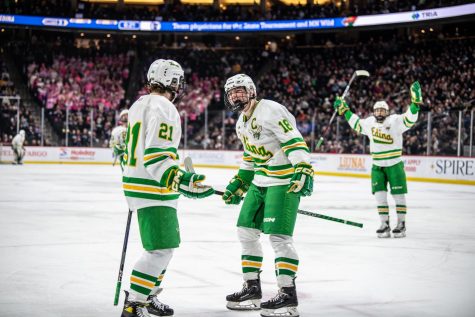 Juniors Bobby Cowan and Jackson Nevers celebrate at the Minnesota Boys Hockey State Tournament.  “I’m just happy—I guess not happy with the way it turned out, but it was an unbelievable experience just getting to go there and then succeed and get into the final game really means a lot to me and, I’m sure, everyone on my team,” Cowan said.