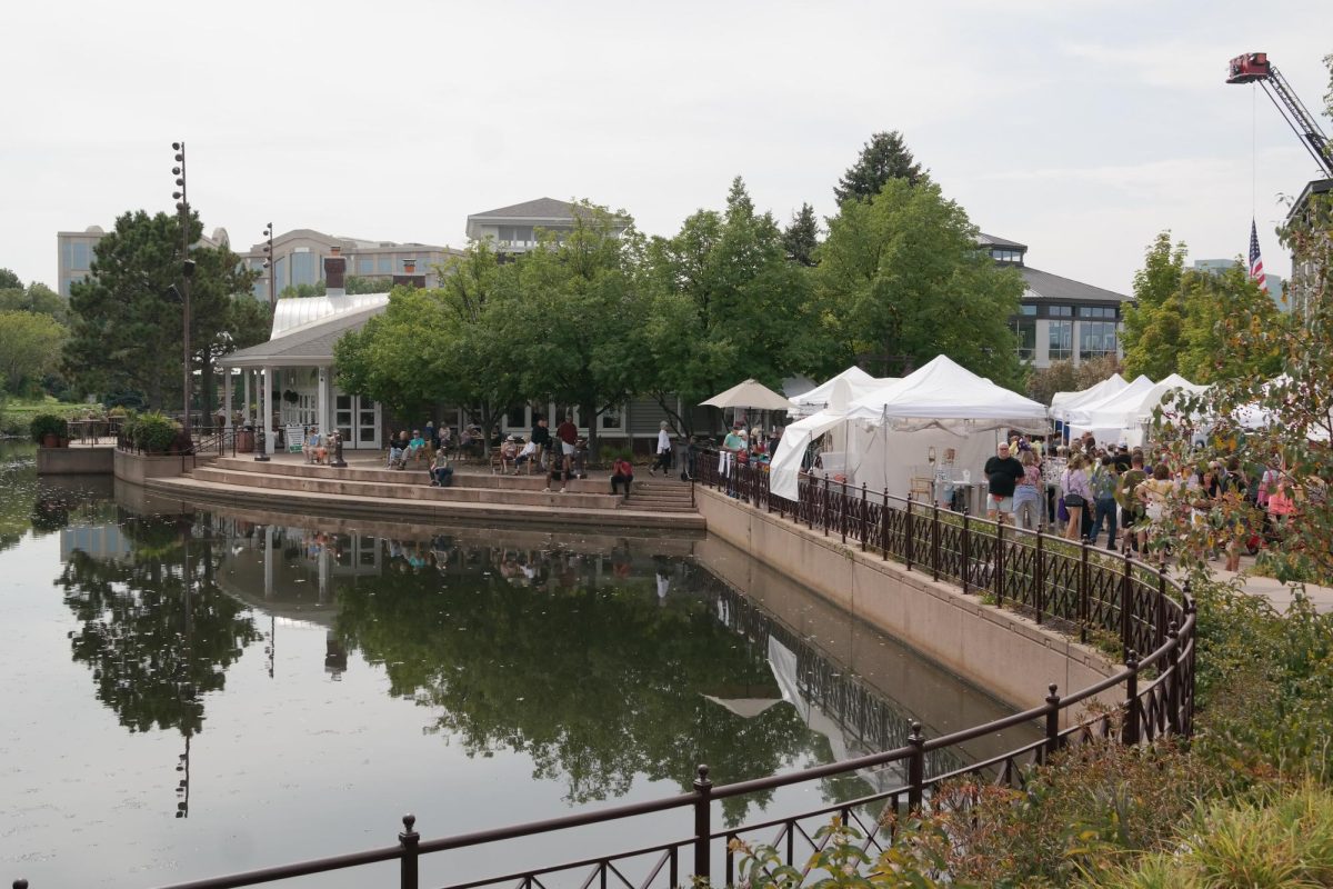 Festival-goers walked along the Centennial promenade as booths and food trucks lined the pathway along the lake.