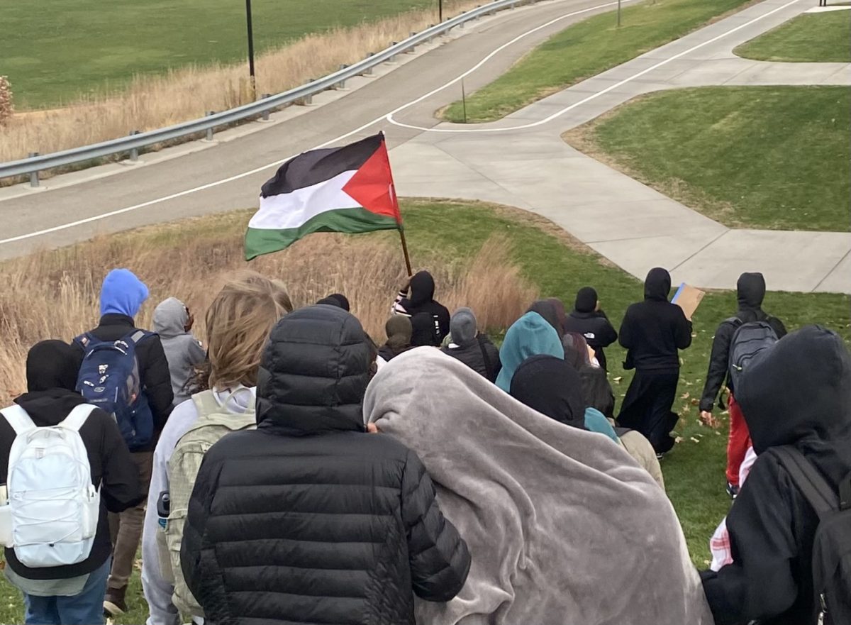 Students+walk+downhill+behind+Edina+High+School+during+the+walkout+for+Palestine.