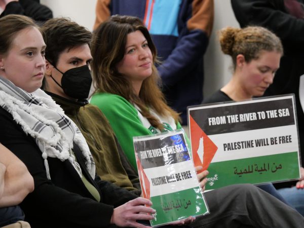 Sarah Quayl, leader of The Edina Moms Facebook group, sitting in the
audience amongst pro-Palestine activists at the School Board Meeting.