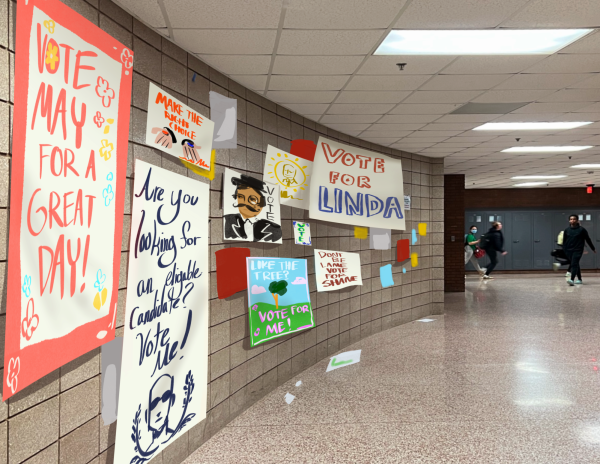 Cartoon posters cover the walls as a testament to their candidates capabilities. 