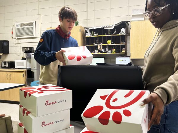 Student Council members Carter Seifert and Ajowa Agyekum prepare a thank-you lunch for Edina High Schools custodial staff. Staff members voted for Chick-Fil-A, and StudCo members organized meals for those working during the day as well as the evening shift. 