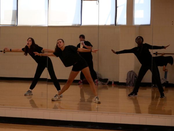 EHS' Hip Hop Team warms up for rehearsal with various full-body stretches. 