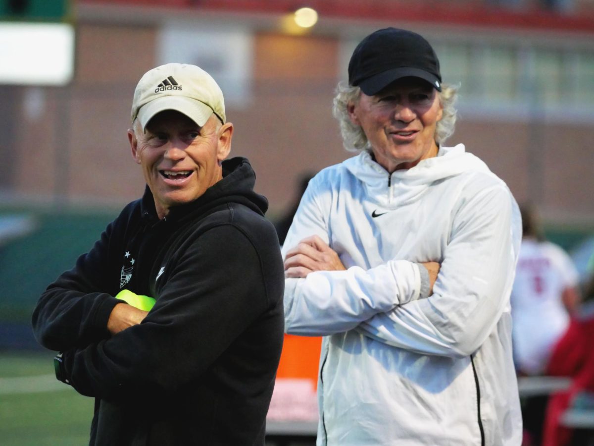 Coaches Bill Garner (left) and Dave Jenson (right) at Kuhlman Field on Tuesday, Oct. 1 before their home game against the Eden Prairie Eagles. Even after their notable accomplishment of 500 wins, Garner and Jenson led the team to yet another win.