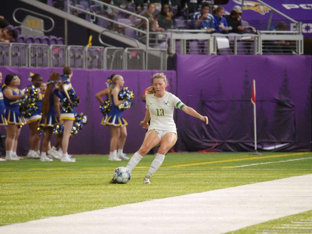 Senior defender Anna Conner dribbles the ball up the sideline.