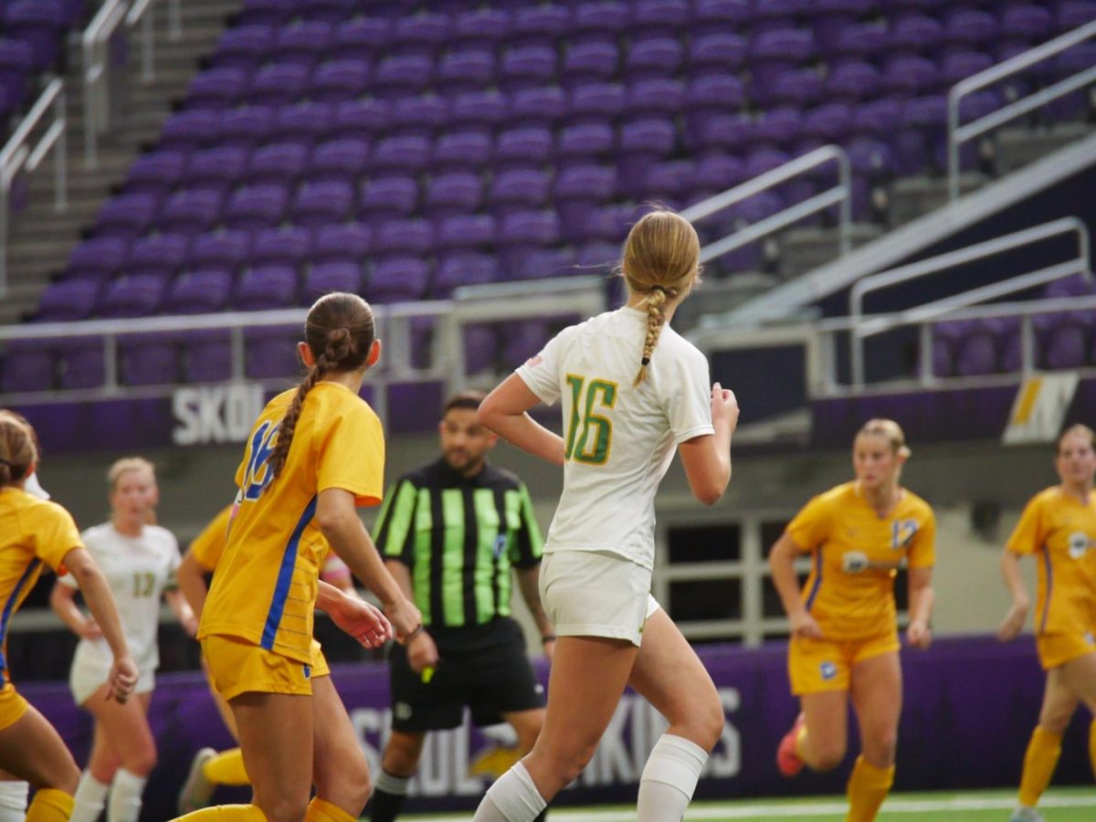 Junior forward Lily Smoley runs in front of a defender to get open for a pass.