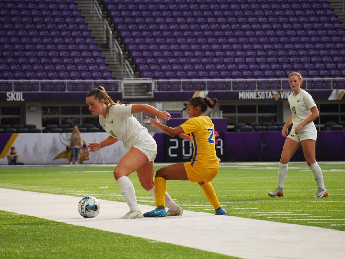 Junior midfielder Evie Kachmarzinski defends the ball against a Wayzata player.