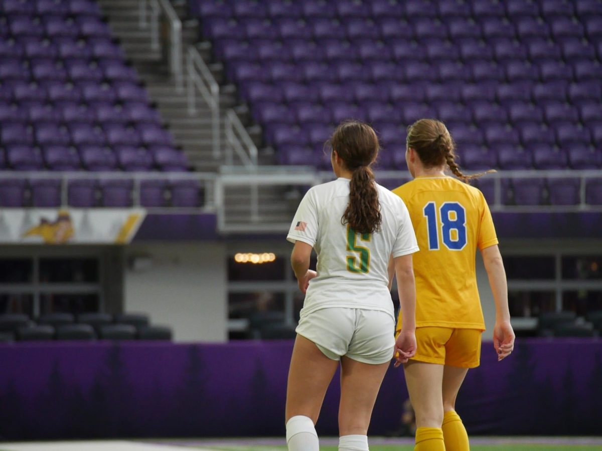 Senior forward Ally Adair trails against Wayzata soccer player.