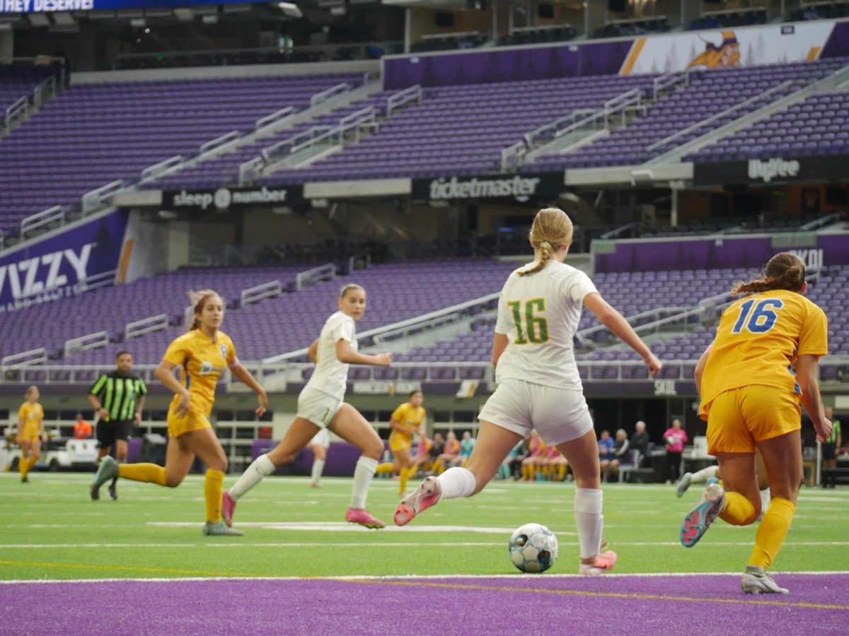 Junior forward Lily Smoley winds up to pass to junior forward Lou Ruffien.