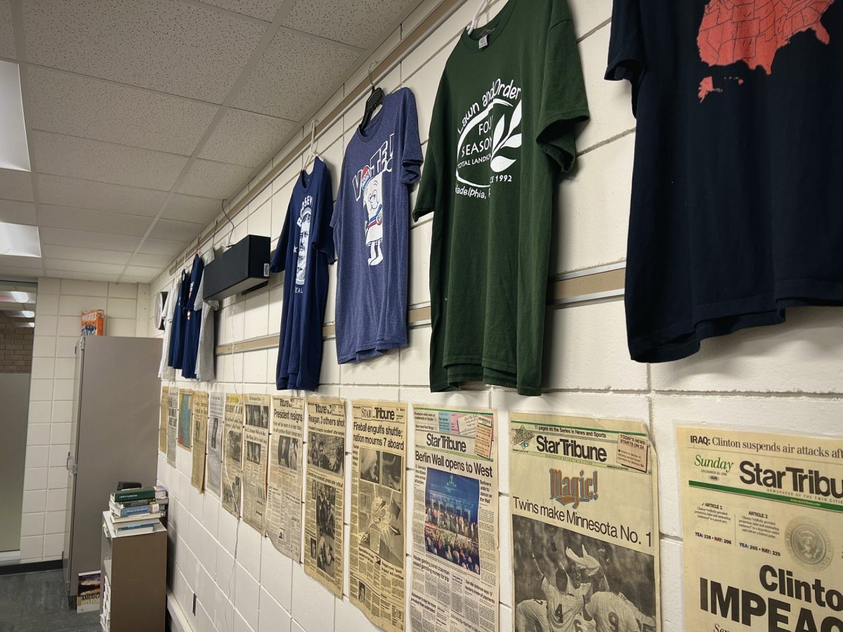 In the back of the classroom where he used to teach AP Government, Erik Anderson uses political t-shirts and historical headlines to fill the walls. Even through curriculum changes, the unique decorations stay where they have been for years.