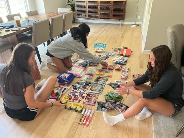 Seniors Eleanor Doscotch, Indra Khariwala, and Ally Adair prepare care packages for hospitals. 

Photo courtesy of Eleanor Doscotch. 