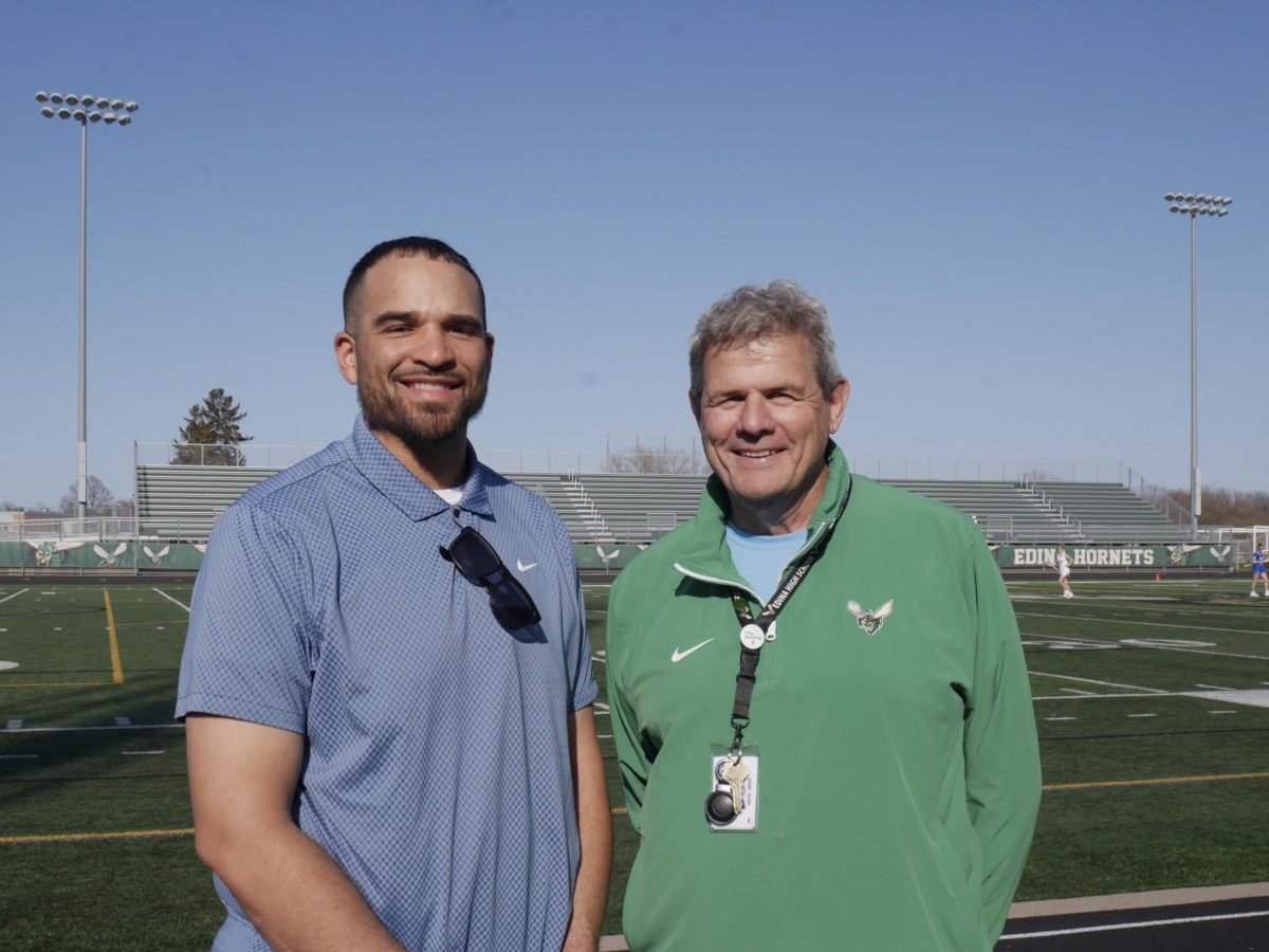 New Assistant Principal William Britt (left) and EHS Principal Paul Paetzel (right) on Tuesday, April 21, cheer on the Edina Girls' Varsity Lacrosse team in their match against Minnetonka.