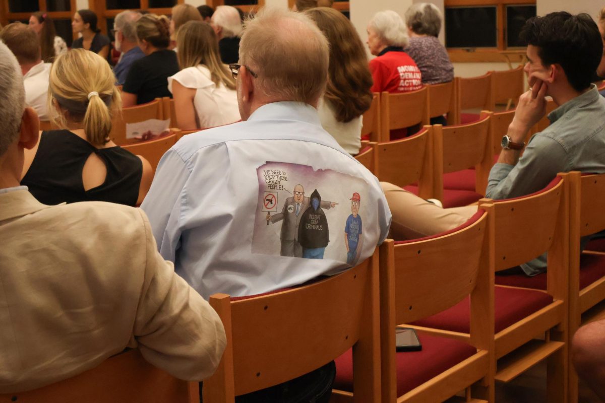 Dale "Lion Dale" Johnson, a 2024 Minnesota House of Representatives candidate, wore a button-up expressing his stance on gun reform.